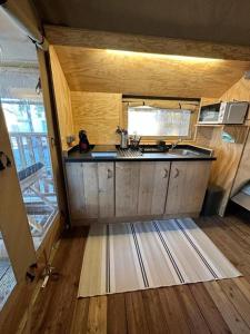 a kitchen with a sink and a counter top at Camping Miramar Playa - tienda familiar in Torredembarra +27 photos