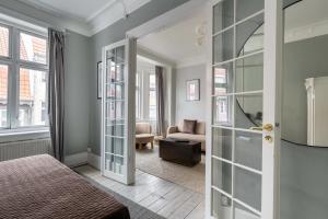 a bedroom with a door leading to a living room at Super Central 2BR Apartment in Old Town Copenhagen in Copenhagen