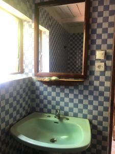 a bathroom with a sink and a mirror at Soanala in Moramanga