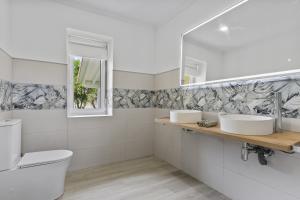 a bathroom with two sinks and a mirror at La Casuca del Músico in Novales +29 photos