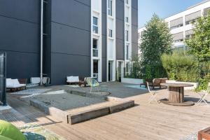 a courtyard with a table and chairs and a building at Student Factory Bordeaux Armagnac in Bordeaux