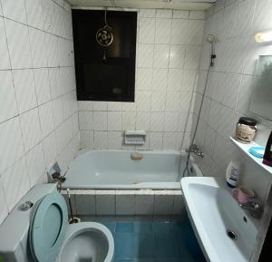 a bathroom with a toilet and a tub and a sink at Managa-naga Room1204 near abu dhabi mall in Abu Dhabi