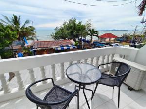 a balcony with two chairs and a table at Beach Villa NA JOMBTIEN ROOF TOP in Na Jomtien