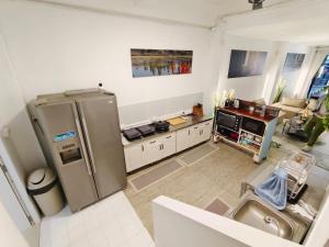 a kitchen with a stainless steel refrigerator in a room at Beach Villa NA JOMBTIEN ROOF TOP in Na Jomtien +6 photos
