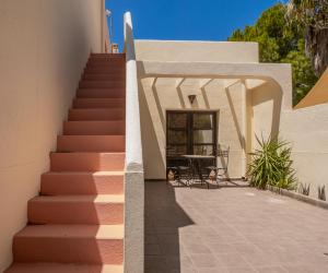 una escalera que conduce a un edificio con una mesa en El Olivo, en San José