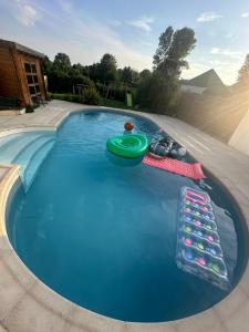 a pool with a frisbee and other toys in it at Maison avec piscine proche de Paris in Groslay