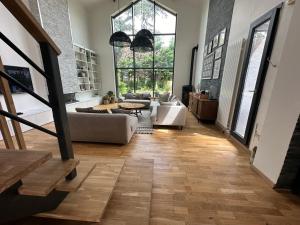 a living room with a couch and a table at Maison avec piscine proche de Paris in Groslay