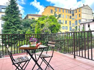 a table and two chairs on a balcony at Hotel Sara in Milan