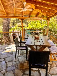 a wooden table and chairs on a patio at Villa Christina in Vourvourou