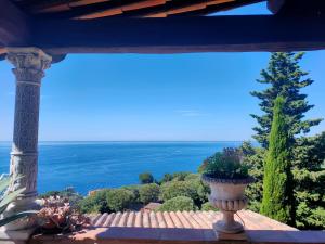 a vase sitting on a balcony with a view of the ocean at Villa Azur Cap d'Ail in Cap d'Ail