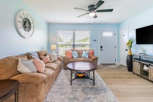 a living room with a couch and a ceiling fan at Charming 3BR Home with Free Parking & Game Room in Panama City