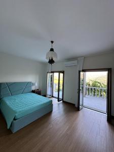 a bedroom with a bed and a sliding glass door at Quinta da Touça in Baião +43 photos