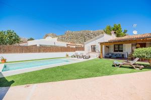 a backyard with a swimming pool and a house at Can Singala 46 in Port de Pollensa
