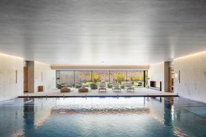a lobby with a swimming pool in a building at The Lince Santa Clara in Vila do Conde