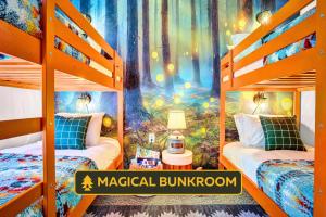 a bedroom with two bunk beds with a forest mural at New Foxfire Haus - Modern - Hot tub Pet-friendly in Blakeslee