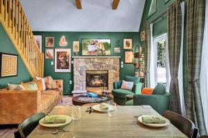 a living room with a table and a fireplace at New Foxfire Haus - Modern - Hot tub Pet-friendly in Blakeslee