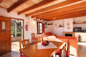 a living room with a table and a couch at Villa Fontxica in Port de Pollensa