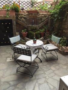 a patio with two chairs and a table and a table and chairs at Varosi Guesthouse in Edessa