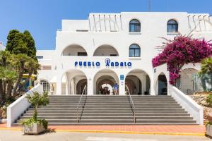 a white building with stairs in front of it at Best Club Vacaciones Pueblo Indalo in Mojácar
