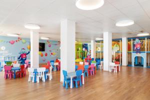 a dining room with colorful chairs and tables in a kindergarten at Best Club Vacaciones Pueblo Indalo in Mojácar