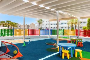 a playground with colorful chairs and tables and a pavilion at Best Club Vacaciones Pueblo Indalo in Mojácar