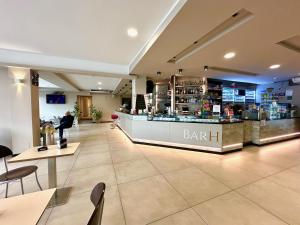 a bar in a restaurant with tables and chairs at Hotel Villabella in San Bonifacio