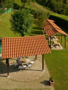 an overhead view of a picnic area with an orange roof at Vigna Dell'Acqua in Santo Stefano Belbo +125 photos