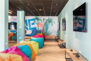 a room with colorful chairs and a mural at Best Club Vacaciones Pueblo Indalo in Mojácar
