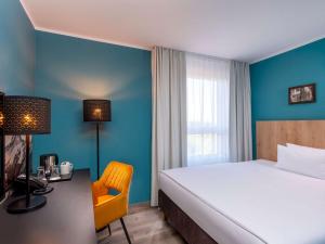 Postel nebo postele na pokoji v ubytování Mercure Hotel München Neuperlach Süd