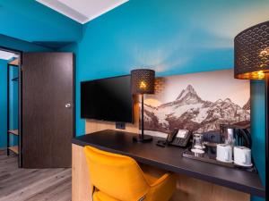 TV a/nebo společenská místnost v ubytování Mercure Hotel München Neuperlach Süd