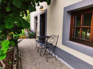 a table and chairs sitting outside of a house at Studio Pr' Oreharjo in Zgornje Gorje
