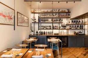 a restaurant with wooden tables and chairs and a bar at FORO Osteria Imperfetta in Civitella in Val di Chiana