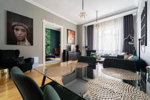 a living room with a glass table and chairs at Heart of City in Budapest