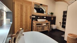un bagno con un lavandino e un water al suo interno di Gewölbe-Chalet am Schöberlhof a Eiselfing Altre 13 foto