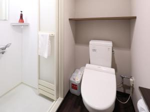 a small bathroom with a toilet and a shower at Dormy Inn Premium Shibuya-jingumae in Tokyo