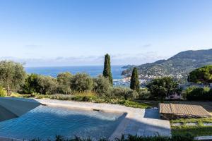 a swimming pool with a view of the ocean at LA CASA DI PIETRA Piscina e Panorama da Sogno in Santa Margherita Ligure