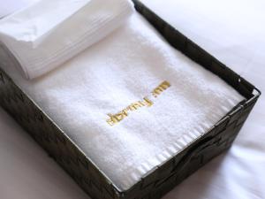 a white napkin in a black box on a bed at Dormy Inn Premium Shibuya-jingumae in Tokyo +37 photos
