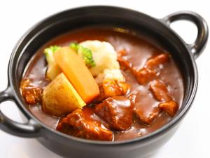 a bowl of stew with meat and vegetables in it at Dormy Inn Premium Shibuya-jingumae in Tokyo