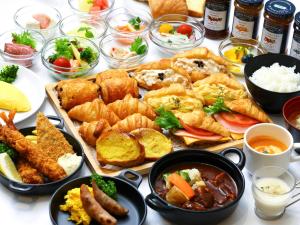 a table with a bunch of different types of food at Dormy Inn Premium Shibuya-jingumae in Tokyo