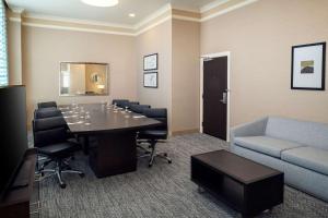 a conference room with a table and chairs and a couch at Embassy Suites Saint Louis - Downtown in Saint Louis +20 photos