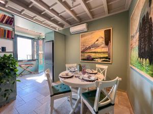 a dining room with a white table and chairs at Montecatini Alto Art View in Nievole