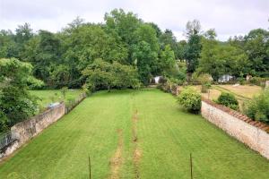 an empty field in a garden with trees at Le Florin d'Or - Bords de Creuse in Saint-Gaultier +32 photos