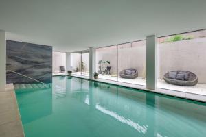 a swimming pool with two tubs in a building at Hilton Lake Como in Como