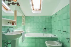a bathroom with a sink and a bath tub at Villa Chiara Lake Como with private garden in Moltrasio
