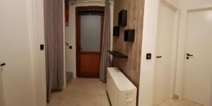 a hallway with a toilet in a room with a door at La Ferme Bleue in Tournai +8 photos