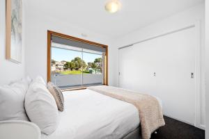 a bedroom with a bed and a large window at Residence at 165 Great for large groups Sleeps 11 in Hobart +40 photos