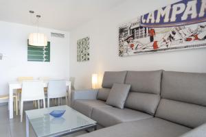 a living room with a couch and a table at Apartamentos Hipocampos Calpe Rent Apart in Calpe