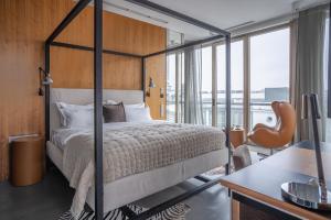 a bedroom with a bed and a desk with a chair at H15 Boutique Hotel, Warsaw, a Member of Design Hotels in Warsaw +61 photos
