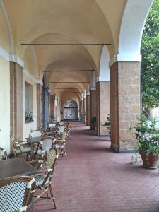 an empty hallway with tables and chairs in a building at Monastero San Lodovico - Orvieto in Orvieto