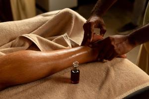 a person in a towel with a bottle of medicine at Ayugiri Ayurveda Wellness Resort Sigiriya in Sigiriya +107 photos